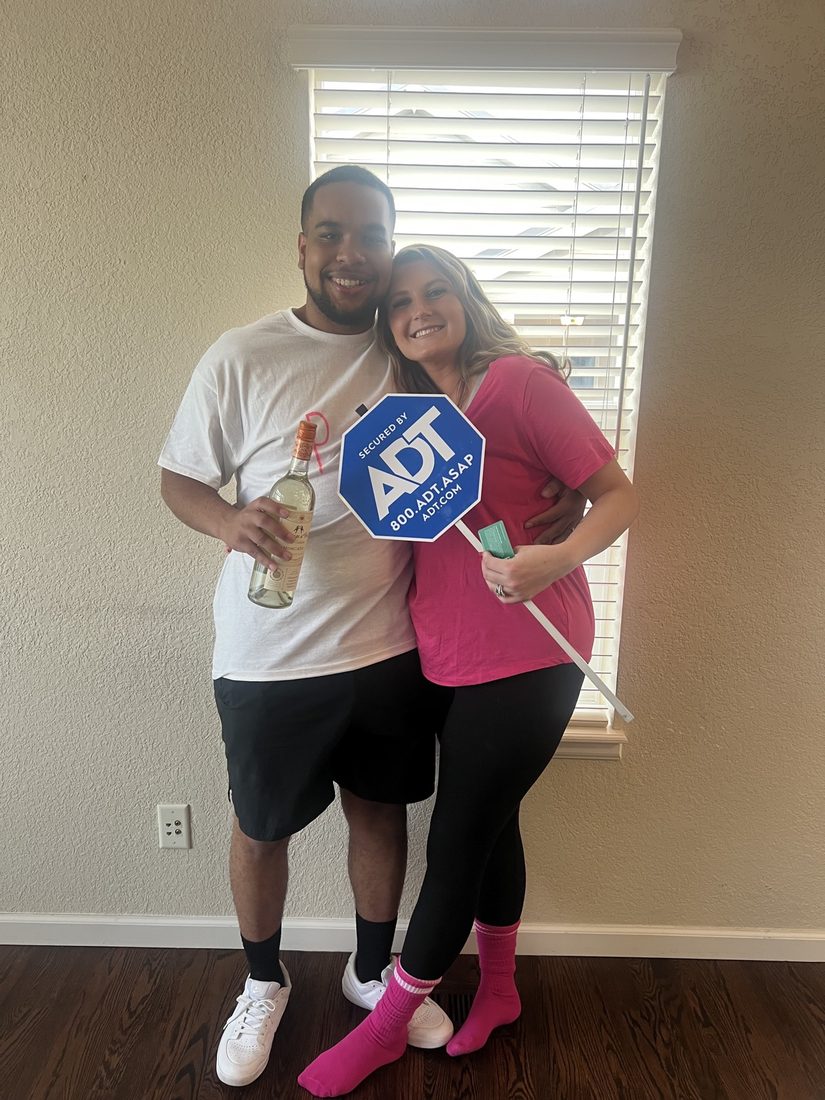 Customers at home with their ADT sign