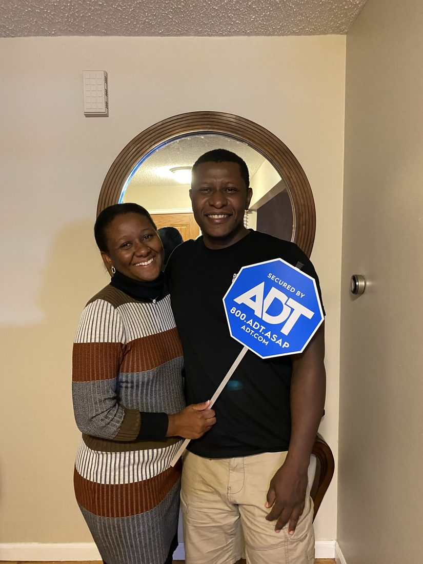 Customers at home with their ADT sign