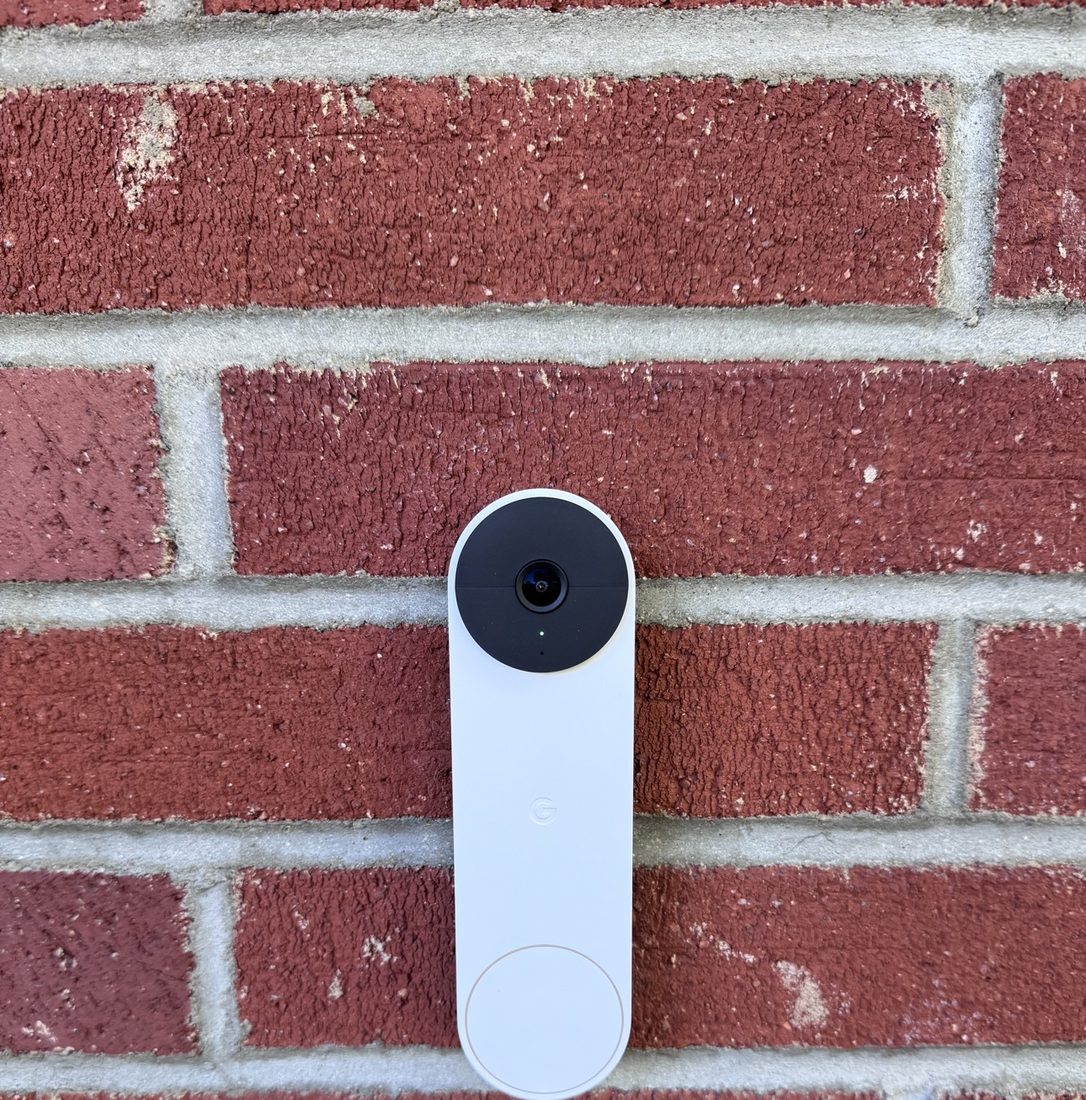 Nest doorbell camera mounted on a brick entry