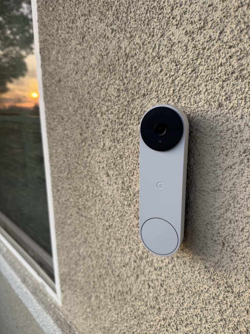 Nest doorbell camera installed beside a front door