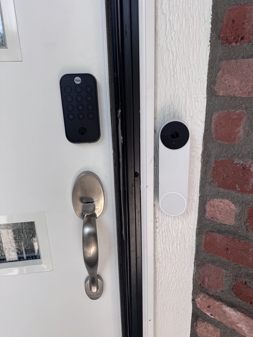 Smart lock and Nest doorbell at a brick entryway
