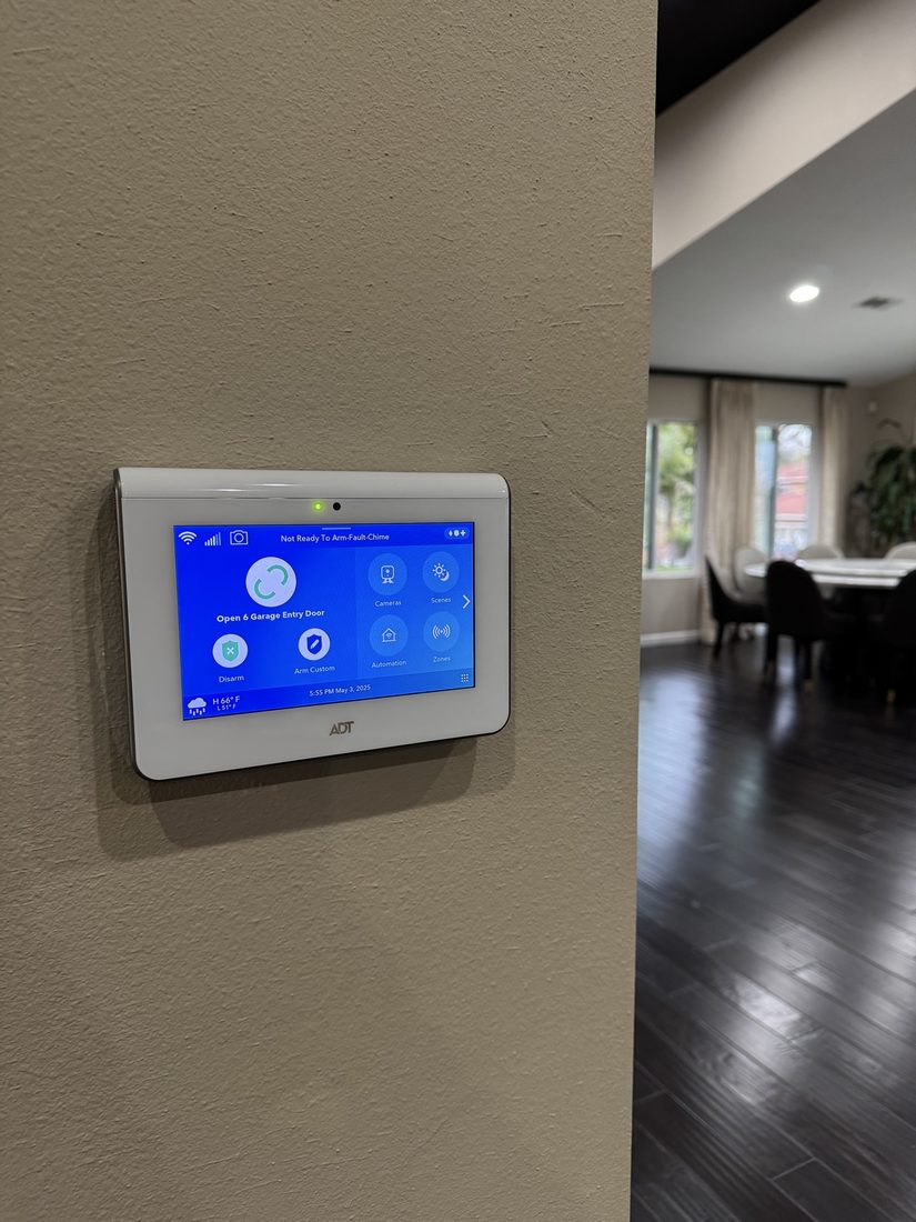 ADT touchscreen panel installed in a dining area